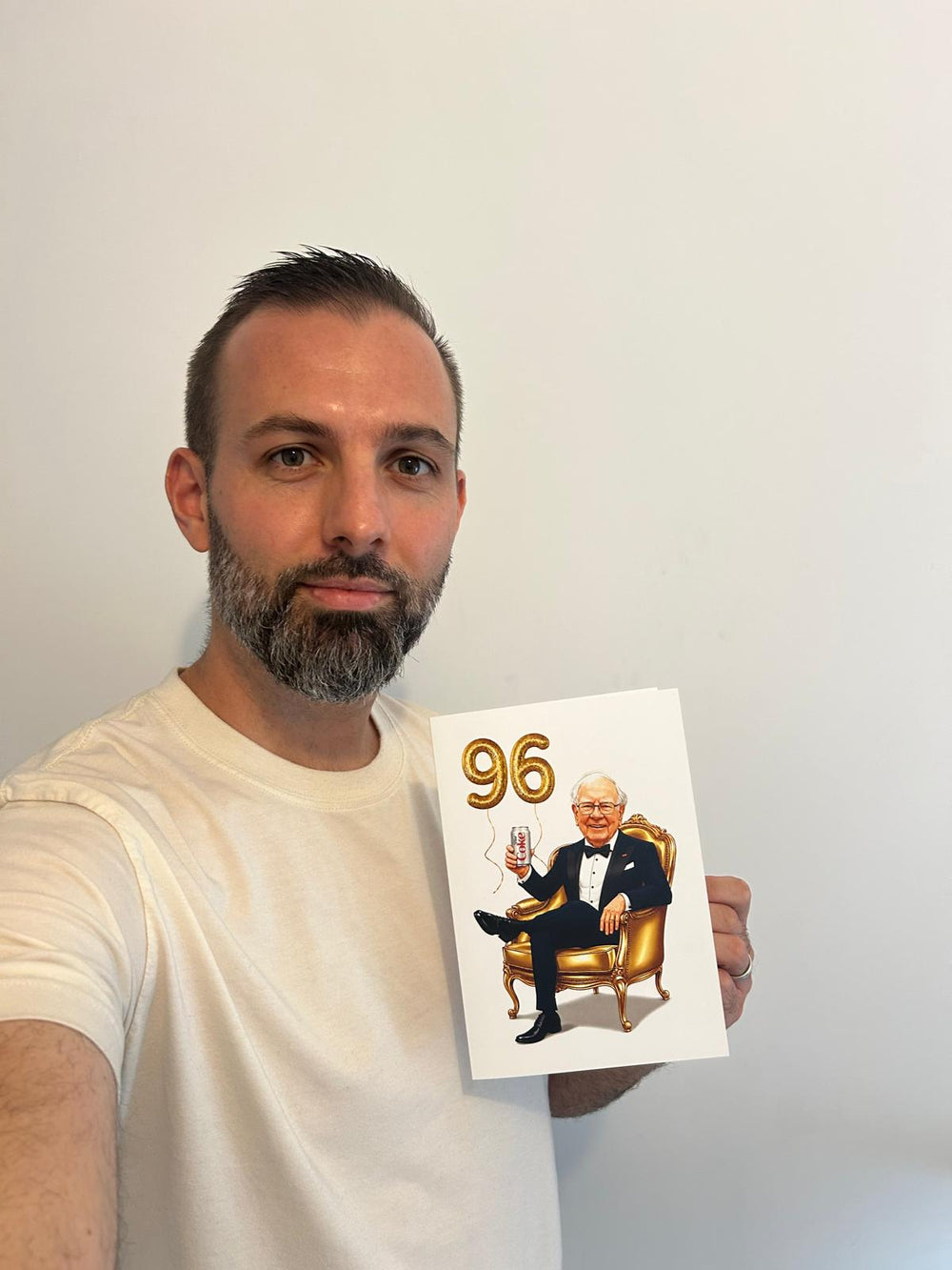 Hugo, founder of Cartoons Portrait, holding the caricature card he drew for Warren Buffett’s 96th birthday
